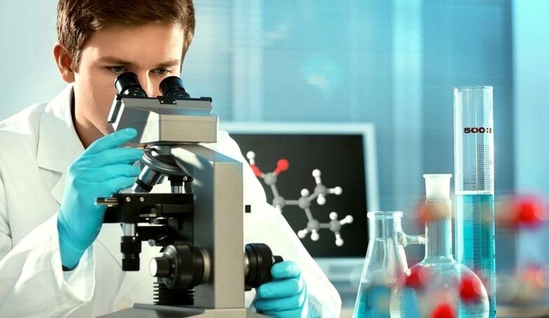 Expert examines material under microscope